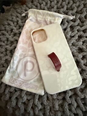 Loopy Case White Marble Phone Case with Burgundy Loopy Strap for IPhone 12 Pro.